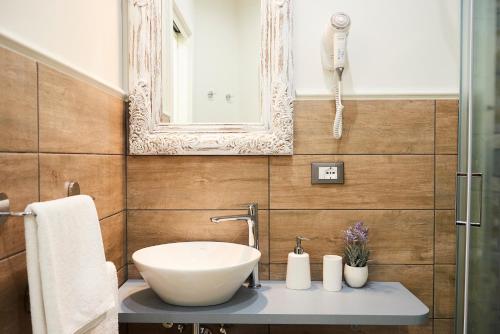 a bathroom with a sink and a mirror at Una Chicca a Roma in Rome