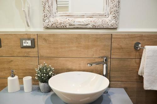 a bathroom with a sink and a mirror at Una Chicca a Roma in Rome