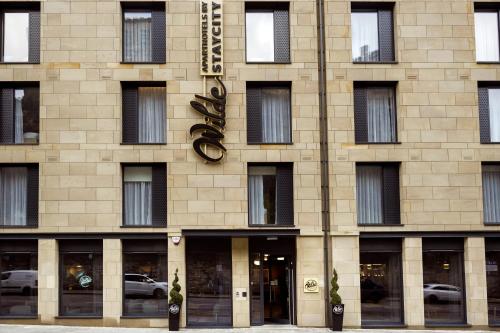 a building with a clock on the front of it at Wilde Aparthotels by Staycity Edinburgh Grassmarket in Edinburgh