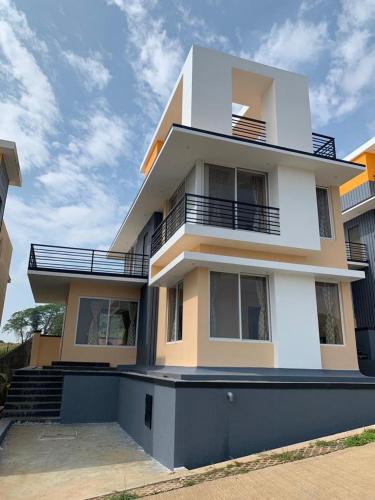 a white building with stairs and balconies on it at ROYAL MEADOWS - IGATPURI Bungalow C in Igatpuri
