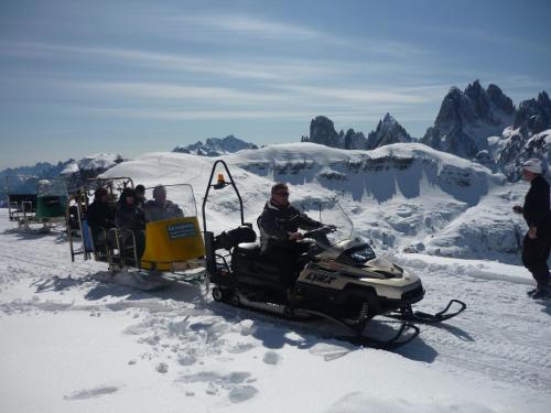 a group of people riding in a snowmobile at Albergo Chalet Lago Antorno in Misurina