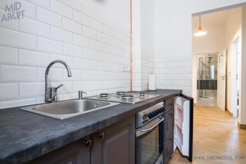 a kitchen with a sink and a counter top at Mid Apart Mennicza Cieszyn in Cieszyn