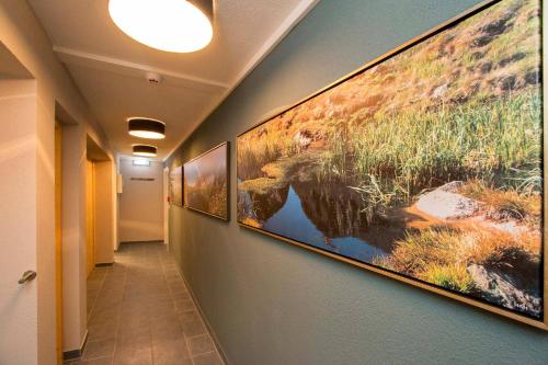 a hallway with paintings on the wall in a hospital at Gurglhof Apartmenthaus in Obergurgl