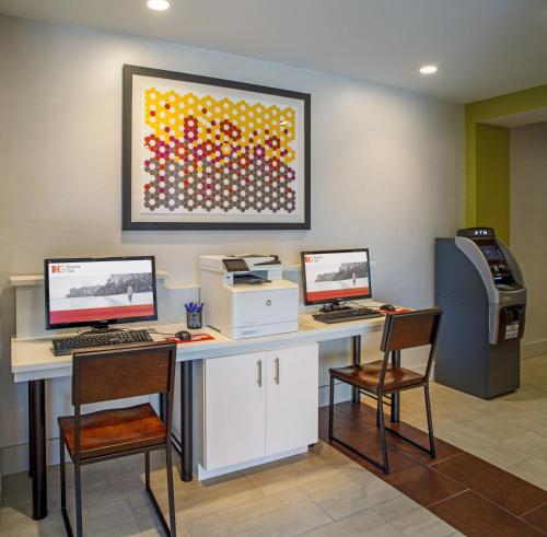 a office with two computer monitors and a printer at Holiday Inn Express Nags Head Oceanfront by IHG in Nags Head