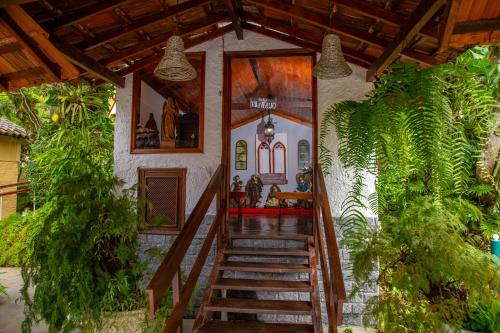 a house with a staircase leading to a room at Hotel Fazenda Vilarejo All Inclusive in Conservatória