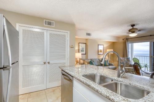 a kitchen with a sink and a refrigerator at Royal Palms #1006 in Gulf Shores