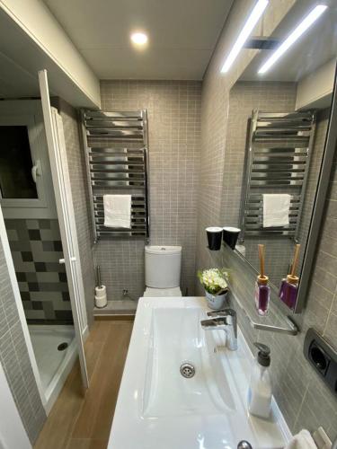 a bathroom with a white sink and a toilet at Apartment Llavaneres II in Sant Andreu de Llavaneres