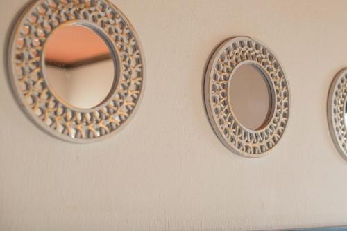 a pair of mirrors hanging on a wall at Charis Guesthouse in Makrinítsa