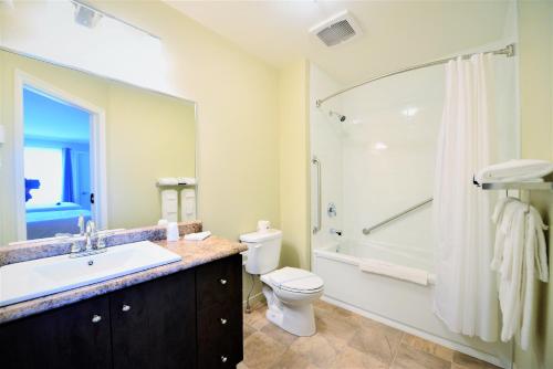 a bathroom with a sink and a toilet and a shower at Motel L'Abri in Carleton sur Mer