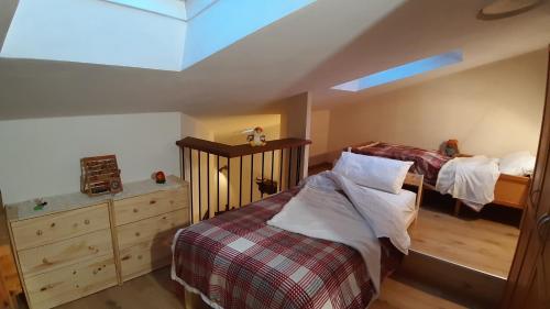 a bedroom with two twin beds and a skylight at Casa Leuca ALBENGA in Albenga