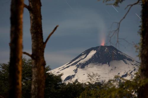 a mountain with a rainbow on top of it at La Escondida Pucon in Pucón