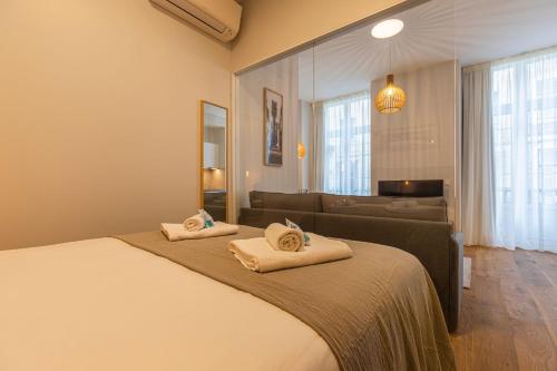 a bedroom with a bed with two towels on it at Upscale & Trendy flat in the Center in Lisbon