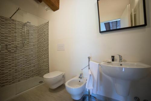 a bathroom with a sink and a toilet and a mirror at Villa Franca Casa Vacanze in Passirano