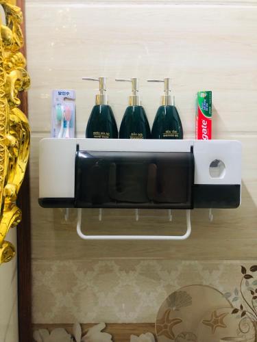 a black and white shelf with three glasses on it at Elisa Hotel in Ninh Binh