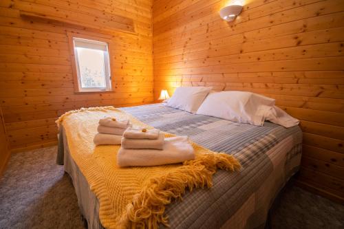 a bedroom with a bed with towels on it at Sundog Retreat in Whitehorse