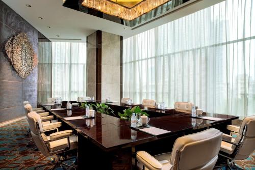 a large conference room with a long table and chairs at Kempinski Hotel Changsha in Changsha