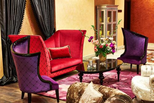 three chairs and a table in a living room at Royal Maxim Palace Kempinski Cairo in Cairo