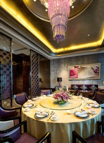 a dining room with a table and a chandelier at Kempinski Hotel Changsha in Changsha