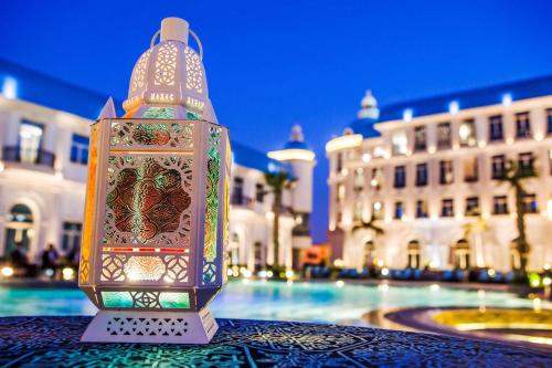 a lantern sitting on a table in front of a building at Royal Maxim Palace Kempinski Cairo in Cairo