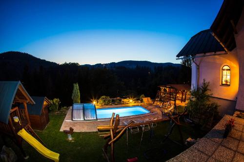a backyard with a swimming pool and a house at APARTMÁNY - Pacholik in Rokytnice nad Jizerou