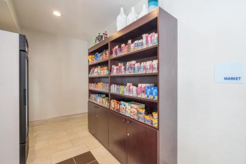 a walk in pantry with shelves filled with food at Holiday Inn Express Hotel Howe / Sturgis by IHG in Howe