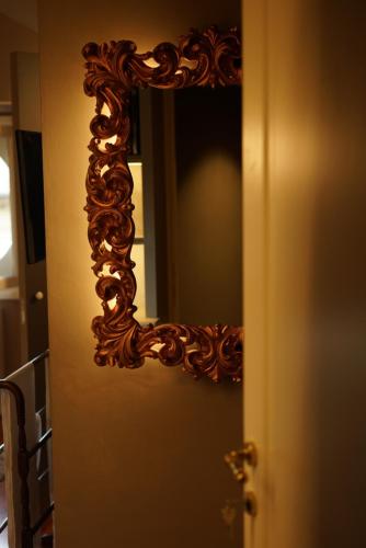 a mirror on the door of a room at L'Americano Luxury Rooms in Chiavari