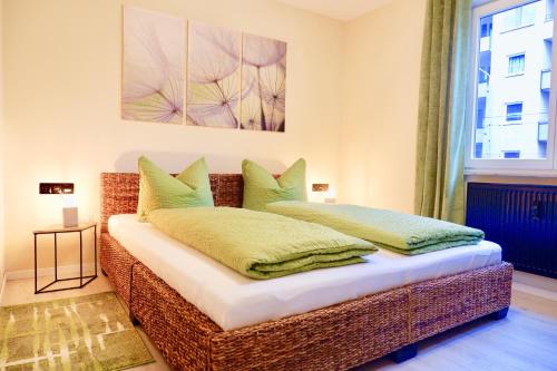 a bedroom with a bed with green pillows at City Flair in Dresden
