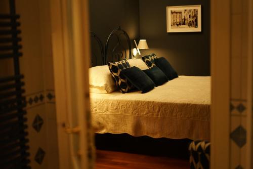 a bedroom with a bed with black and white pillows at L'Americano Luxury Rooms in Chiavari