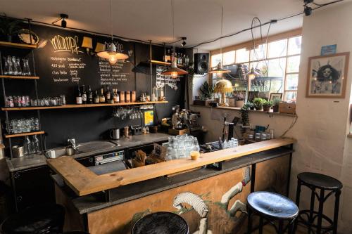 a bar in a restaurant with a counter and stools at Montagu Hostel in Innsbruck