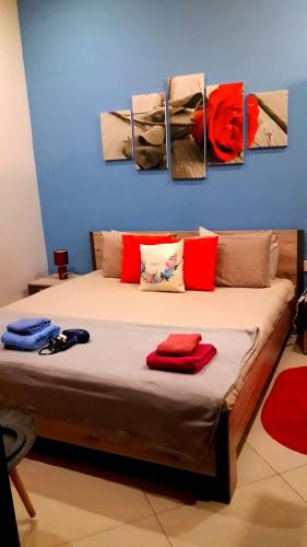 a bedroom with a bed with four paintings on the wall at Cittadella b&b in Victoria