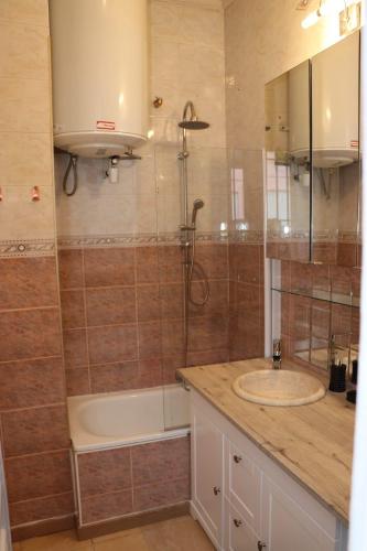 une salle de bain avec une baignoire, un lavabo et une douche dans l'établissement Maison Niçoise au calme vue mer, à Nice