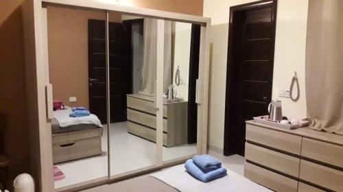 a bathroom with a large mirror and a dresser at Cittadella b&b in Victoria