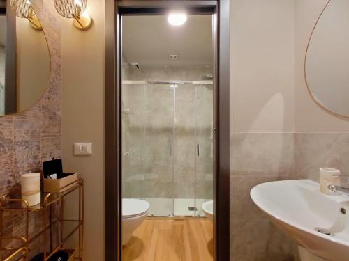 a bathroom with a shower and a toilet and a sink at INTOMILAN Galleria Duomo I Boutique & Design Aparthotel in Milan