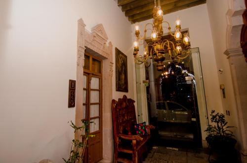 a hallway with a chandelier next to a door at Hotel Posada San Miguel in Jerez de García Salinas