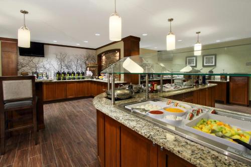 a large kitchen with a buffet with food on a counter at Staybridge Suites Tysons - McLean by IHG in McLean