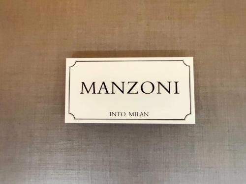 a sign that says manonymoit on a wall at INTOMILAN Galleria Duomo I Boutique & Design Aparthotel in Milan