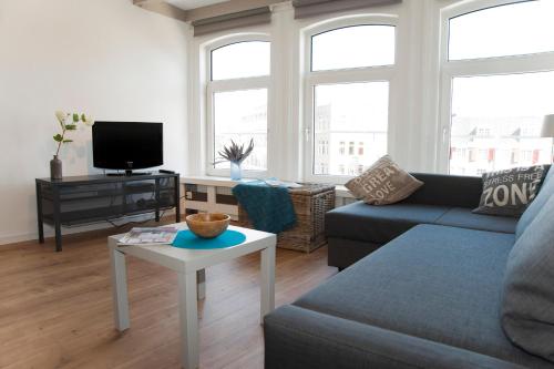 a living room with a couch and a table at Residence Flower Market in Amsterdam