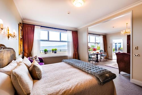 a bedroom with a large bed with a large window at On The Point - Lake Rotorua in Rotorua