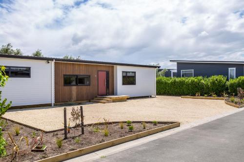 a house with a courtyard with a garden at Burgundy Place in Martinborough 