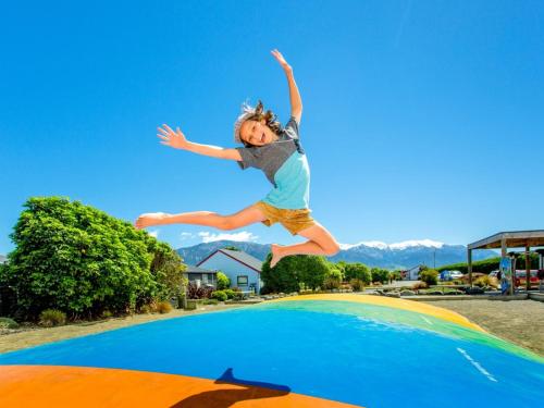 a young boy jumping on top of a trampoline at Kaikoura TOP 10 Holiday Park in Kaikoura
