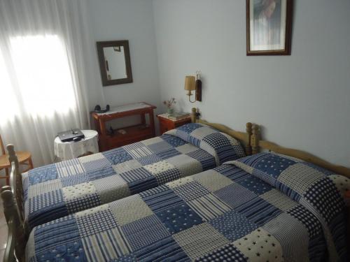 A bed or beds in a room at Residencial Peñiscola Playa 6 LEK