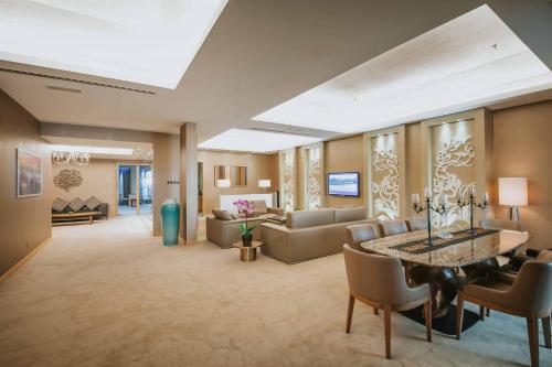 a living room with a couch and a table at Ancasa Royale, Pekan Pahang in Pekan