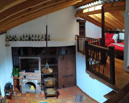 a living room with a staircase and a fireplace at Cabañas & Glamping De Ruana Por Boyacá in Paipa