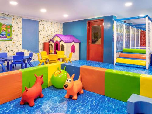 a childrens play room with colorful furniture and toys at Novotel Bahrain Al Dana Resort in Manama