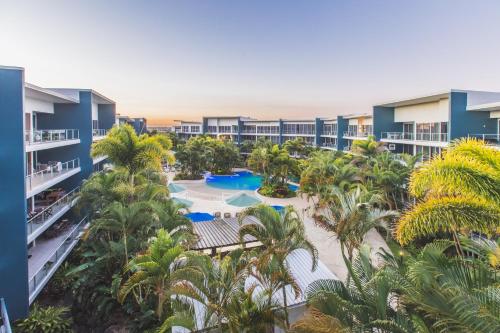 an aerial view of a resort with palm trees and a pool at Azzura Greens Resort in Gold Coast