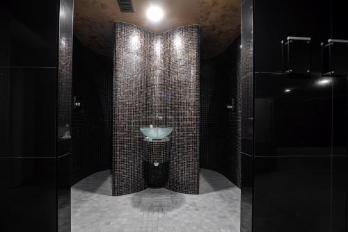 a bathroom with a toilet and a sink at Apartment Elegance Hrebienok in Smokovce