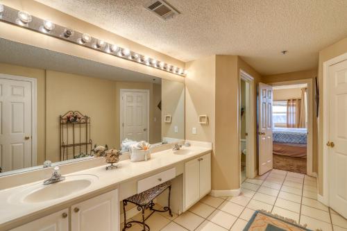 a bathroom with two sinks and a large mirror at Enclave 605 in Orange Beach