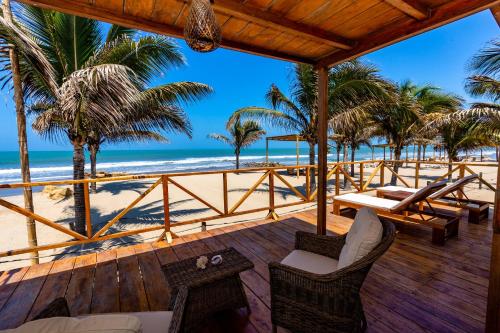 a view of the beach from the deck of a resort at Hotel Punta Camarón Bungalows & Suites in Zorritos