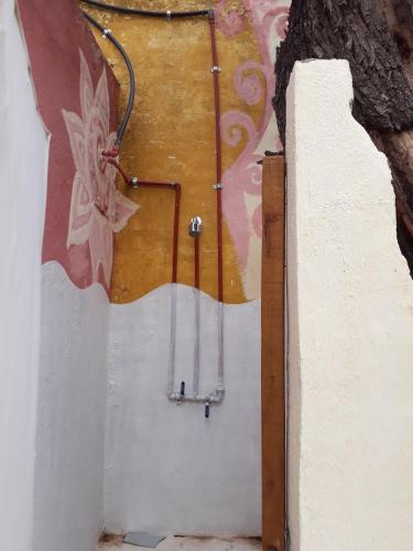 a door in a wall with a painting on it at Posada Arco Iris in San Marcos Sierras