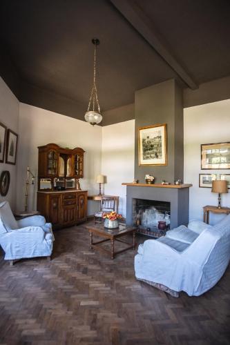 a living room with two beds and a fireplace at El Rolito in Sierra de la Ventana
